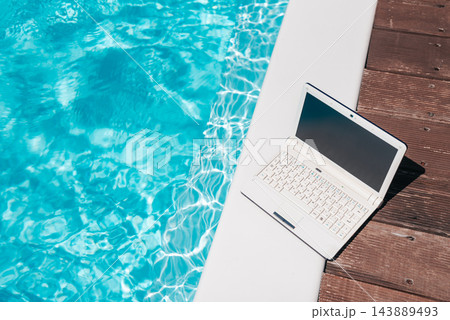 Remote Work by the Swimming Pool with Laptop Mockup Remote Work by the Swimming Pool with Laptop Mockup 143889493