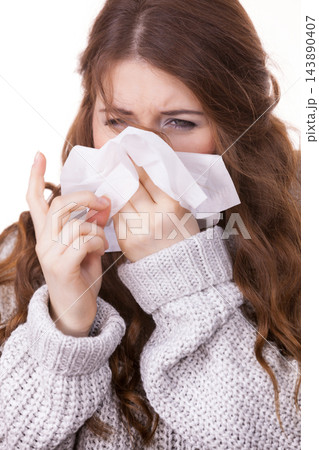 Sick freezing woman sneezing in tissue 143890407