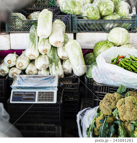 Chinese cabbage, scale and fresh vegetables at authentic local market stall Chinese cabbage, scale and fresh vegetables at authentic local market stall 143891261