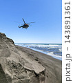 A Russian National Guard multi-purpose helicopter from the Mi-8 family flies over Khalaktyrsky Beach at an extremely low altitude in clear weather. Kamchatka, Russia. 143891361