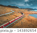 Aerial view of red train near azure mountain lake in autumn 143892654