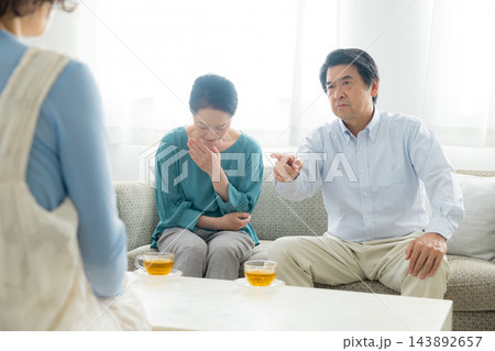 家族会議するシニア夫婦と娘 家族会議するシニア夫婦と娘 143892657
