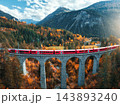 Aerial view of red train on Landwasser viaduct in autumn in Alps 143893240