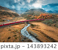 Aerial view of red train, river, mountains, orange hills in fall 143893242