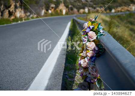 Flowers memorial symbol in a road 143894627