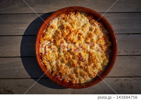 pasta Fisarmoniche gratin with cheese and tomato pasta Fisarmoniche gratin with cheese and tomato 143894756