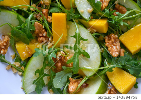 Arugula mango and apple salad healthy Arugula mango and apple salad healthy 143894758