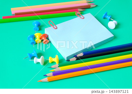 Color pencils with sticky paper and push pins on background. Color pencils with sticky paper and push pins on background. 143897121