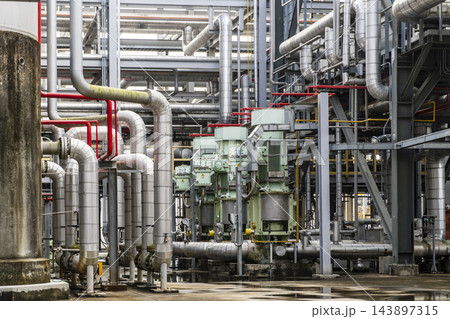 Heavy duty industrial motor pumps and insulated metal pipeline system in a chemical refinery. 143897315