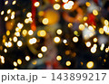 Abstract blurred golden Christmas lights background with warm bokeh effect and dark holiday mood. 143899217