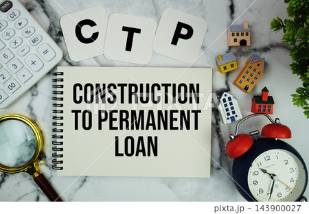 C to P Construction to Permanent Loan text written on notepad with house model, calculator, magnifying glass and alarm clock on marble background 143900027