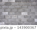 Concrete block wall forms an industrial background texture for construction and architecture 143900367