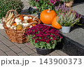 Pumpkin display with chrysanthemums and heather outdoors for autumn harvest decoration 143900373