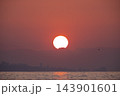 Spectacular Crimson Sunrise Over Sea and Cityscape. 143901601