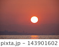 Dramatic Sunrise Over the Sea with City Silhouette and Airplane. 143901602