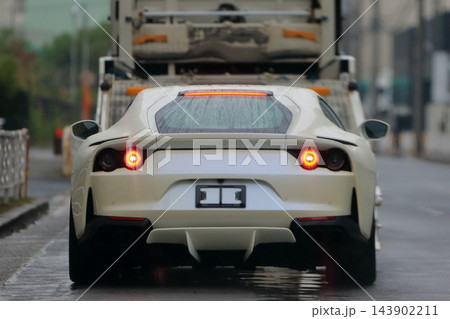 キャリアカーから降車中のスポーツカー 143902211