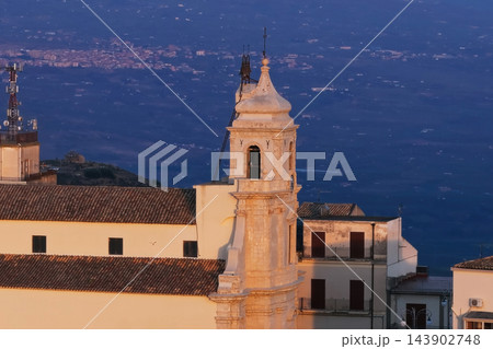 Baroque church bell tower in Centuripe lit by sunset with valley view, Sicily, Italy Baroque church bell tower in Centuripe lit by sunset with valley view, Sicily, Italy 143902748
