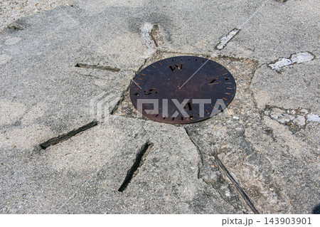 Nitra, Slovakia - May 29, 2024: Compass direction disk on stone pavement Nitra, Slovakia - May 29, 2024: Compass direction disk on stone pavement 143903901