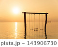 Wooden swings over calm tropical sea at sunrise 143906730