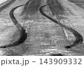 Black tire mark on race track from race car burnout skid mark, Skid marks on asphalt road surface, Curved black tire skid marks. 143909332