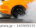 Car wheel burn rubber tire warming, Drag racing car burns rubber off its tires in preparation for race, Car burnout wheels tire with white smoke, Car wheel burnout with smoke from the spinning tire. 143909335