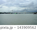 Wide angle view of Vidyasagar Setu cable stayed bridge over Hooghly river with ships under cloudy sky in Kolkat 143909562