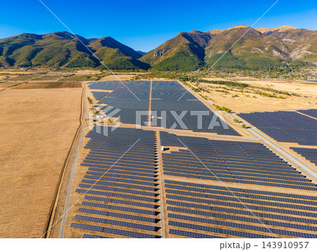 Large solar panel field in a rural area surrounded by mountains and farmland on a sunny day Large solar panel field in a rural area surrounded by mountains and farmland on a sunny day 143910957