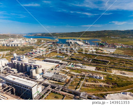 Industrial complex with processing buildings and pipe networks on the coast of Gibraltar Industrial complex with processing buildings and pipe networks on the coast of Gibraltar 143911353