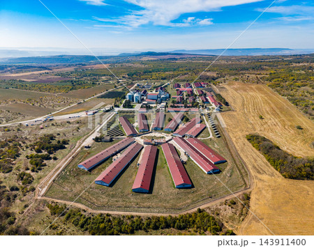Aerial view of a prison complex with rows of buildings and farmland in a rural region during daytime 143911400