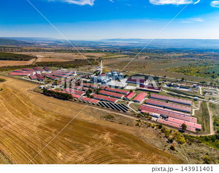 Aerial view of an agricultural production complex surrounded by fields in a rural landscape 143911401