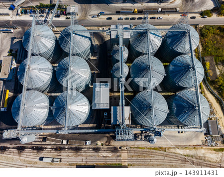 Aerial view of grain silos and conveyor equipment at an industrial storage facility during daytime 143911431