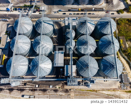 Aerial view of grain silos and conveyor equipment at an industrial storage facility during the day 143911432