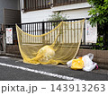 ゴミ集積所に設置された防鳥ネットとゴミ袋 143913263