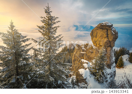 Stunning winter mountain landscape with fantastic rock formation at sunset Stunning winter mountain landscape with fantastic rock formation at sunset 143913341