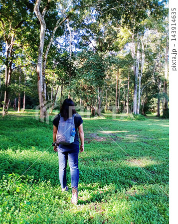 Asian woman with backpack travel and walking into the tropical forest in Thailand 143914635