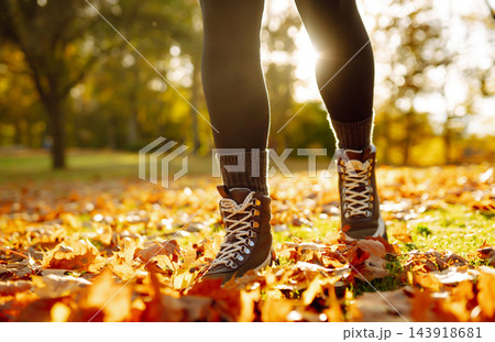 Women's feet walk on autumn leaves in the forest. Rest, relaxation, lifestyle concept. 143918681