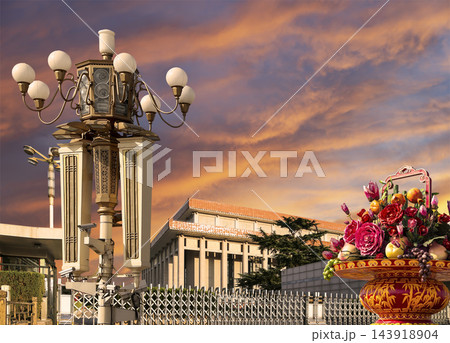 Mausoleum of Mao Zedong with street lamp and huge flower basket (against the sunset), Tiananmen Square, Beijing, China 143918904