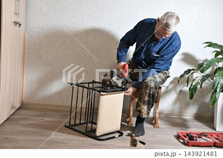 using electric drilling on wooden board using electric drilling on wooden board 143921481