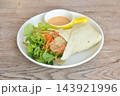 roti flour wrap grilled chicken with fresh vegetable salad dressing spicy mayonnaise cream sauce on plate 143921996