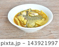 boiled red mango fish with pickled bamboo shoot in spicy and sour yellow curry soup Thai southern food on bowl 143921997