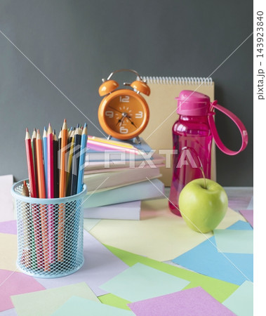 A workspace with school supplies and an alarm clock for studying. School supplies and study materials on a desk. "Back to school" concept.  143923840