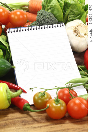 Fresh Vegetables With Blank Recipe Notebook on Kitchen Table Fresh Vegetables With Blank Recipe Notebook on Kitchen Table 143924476