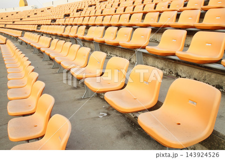 Empty Stadium Bleachers with Orange Seats in Wide Angle View 143924526