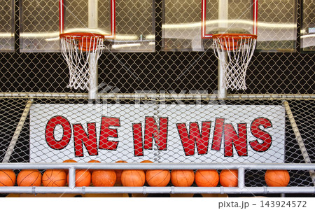Basketball Arcade Game Hoops Behind Chain Link Fence Basketball Arcade Game Hoops Behind Chain Link Fence 143924572