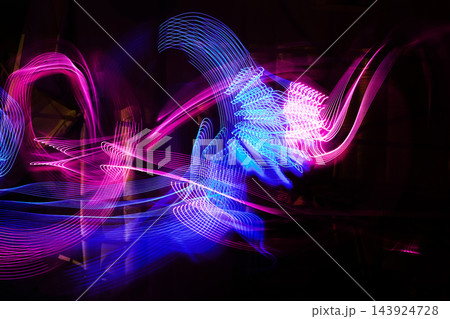 Abstract neon light painting with flowing blue and magenta trails Abstract neon light painting with flowing blue and magenta trails 143924728