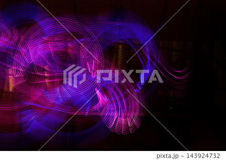 Abstract neon light painting creating blue and magenta motion trails Abstract neon light painting creating blue and magenta motion trails 143924732