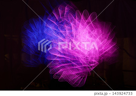 Abstract magenta and blue light trails in long exposure 143924733