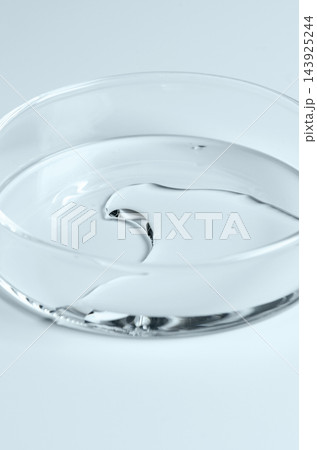 Testing a transparent cosmetic product in a Petri dish. 143925244
