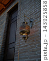 Antique Oriental Metal Lantern Glowing with Warm Amber Light on Brick Wall. Uzbekistan. 143925858