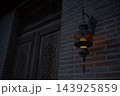 Antique Oriental Metal Lantern Glowing with Warm Amber Light on Brick Wall. Uzbekistan. 143925859